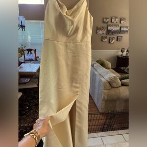 Gold-tone spaghetti strap evening dress with slit up the front-side.